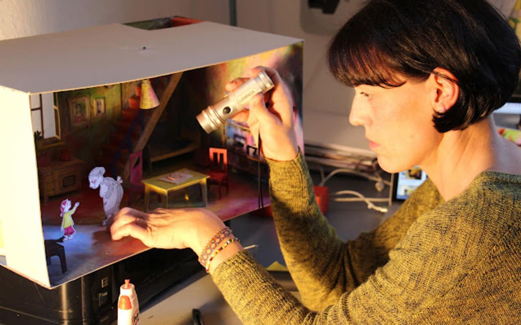 Antje Damm lighting the diorama for The Visitor