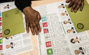 Ballot papers are laid on a table at a polling station as people arrive to vote in snap twin Turkish presidential and parliamentary elections in Istanbul.