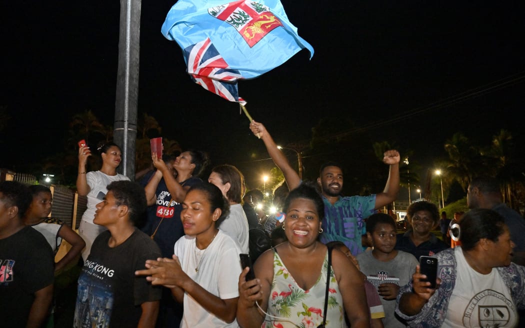 Workers and supporters of People's Alliance Party celebrate after securing the support of the Social Democratic Liberal Party (SODELPA) to form a new government in Suva on 20 December, 2022.