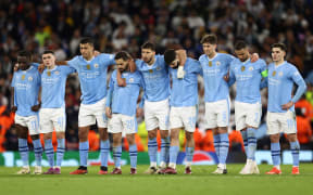 Manchester City players react during the penalty shootout during the UEFA Champions League quarter-final second-leg football match against  Manchester City, 2024.