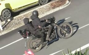 Two people fled the scene on a black, farm-style motorbike.