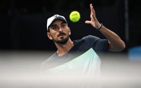 Lebanon's Hady Habib eyes the ball as he hits a shot against China's Bu Yunchaokete during their men's singles match on day one of the Australian Open tennis tournament in Melbourne on January 12, 2025. (Photo by Paul Crock / AFP) / -- IMAGE RESTRICTED TO EDITORIAL USE - STRICTLY NO COMMERCIAL USE --