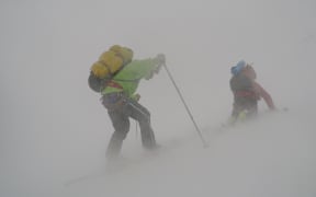 Tom MacTavish struggles against one of the violent squalls that struck the team during their crossing