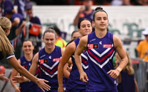 Fremantle Dockers AFLW team lead out by New Zealand's Ange Stannett.