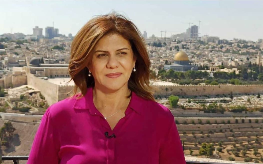 (FILES)This undated handout file photo released by the Doha-based Al-Jazeera TV, shows the channel's veteran journalist Shireen Abu Aqleh (Akleh) during one of her reports from Jerusalem. - Israeli Defense Minister Benny Gantz said on November 14, 2022, that he would not cooperate with a US investigation into the shooting death of a Palestinian-American journalist, likely at the hands of an Israeli soldier.
