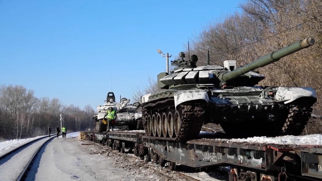 Footage released by Moscow on 16 February 2022 shows Russian soldiers loading tanks and military equipment on to railway platforms after a drill near Ukraine.