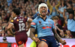 Brian To'o of the Blues celebrates scoring a try.