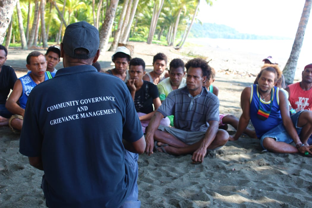 A community officer speaks to young men at Kokana Village on Makira.