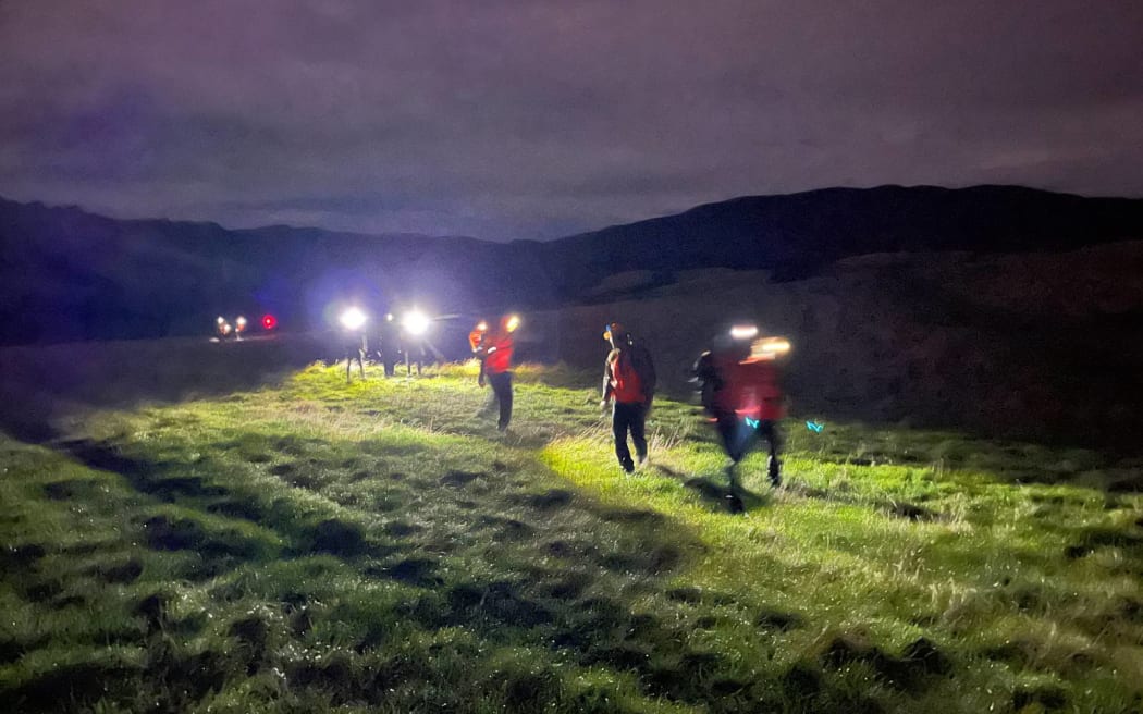 Volunteers search for missing teenagers in Makarewa Falls.
