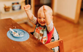 triumphant boy toddler eating