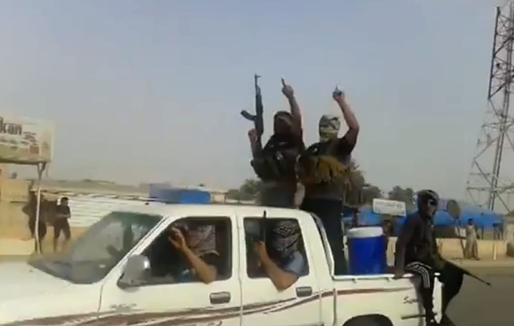 An image taken from a video uploaded on Youtube allegedly shows militants from the Islamic State of Iraq and Syria (ISIs) parading  in the northern city of Baiji.