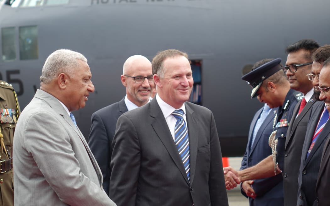 Fiji's Prime Minister Frank Bainimarama receives his NZ counterpart, John Key, at Suva Airport.