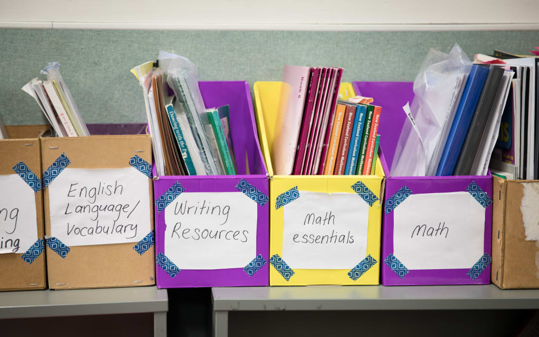 Primary school learning resources on a classroom shelf. Includes Math and Vocabulary as well as other resources.
