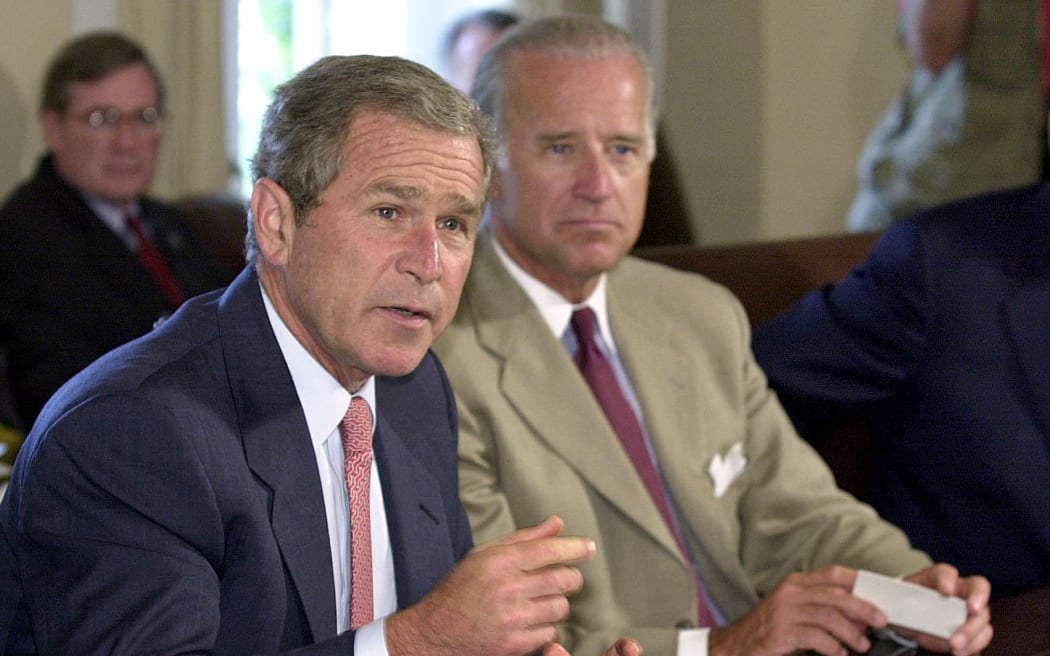 US President George W. Bush (L) answers reporter's questions prior to a bipartisan meeting with congressional leaders in the Cabinet Room of the White House, 25 July 2001.