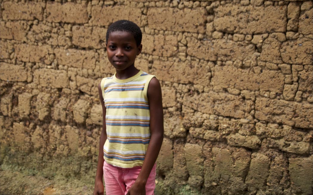 12-year old Rosaline Koundiano pictured in Gueckedou in eastern Guinea, 16 October 2014. Rosaline was one of the first children to survive the ebola virus. It took weeks, however, before she was accepted again into her community.