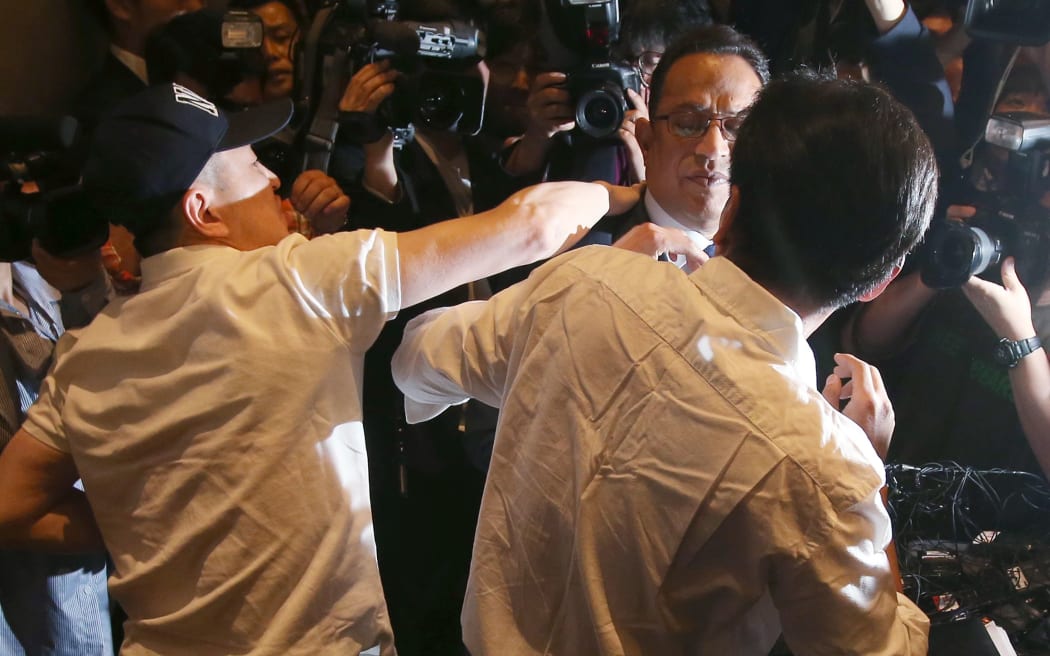 Atar Safdar (C), the head of Oxy Reckitt Benckiser Korea, is surrounded by the aggrieved relatives of victims.