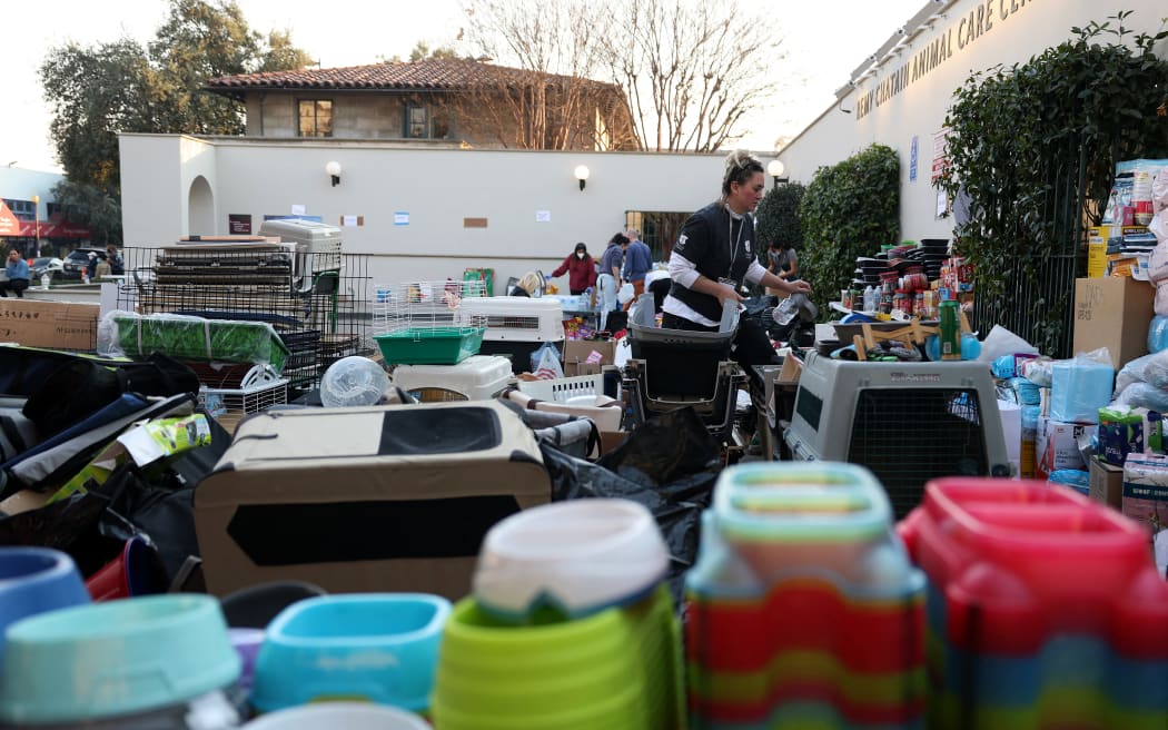PASADENA, CALIFORNIA - JANUARY 10: A volunteer arranges donated pet items at the Pasadena Humane Society on January 10, 2025 in Pasadena, California. Hundreds of pets have been displaced by the Eaton Fire and many residents have had to shelter their pets at the Pasadena Humane Society. The Eaton Fire has grown to over 13,000 acres and has destroyed over 5,000 homes and businesses. Five people have lost their lives in the fire.   Justin Sullivan/Getty Images/AFP (Photo by JUSTIN SULLIVAN / GETTY IMAGES NORTH AMERICA / Getty Images via AFP)