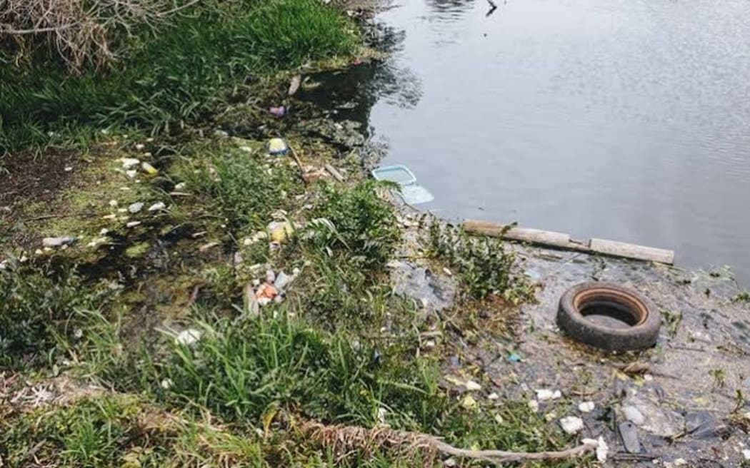 Rubbish including tyres, shopping trolleys, plastic containers and bottles and other household waste clogs parts of the Puhinui Stream.