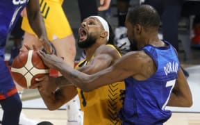 Patty Mills #5 of the Australia Boomers is fouled by Kevin Durant #7 of the United States during an exhibition game ahead of the Tokyo Olympic Games on July 12, 2021 in Las Vegas, Nevada.