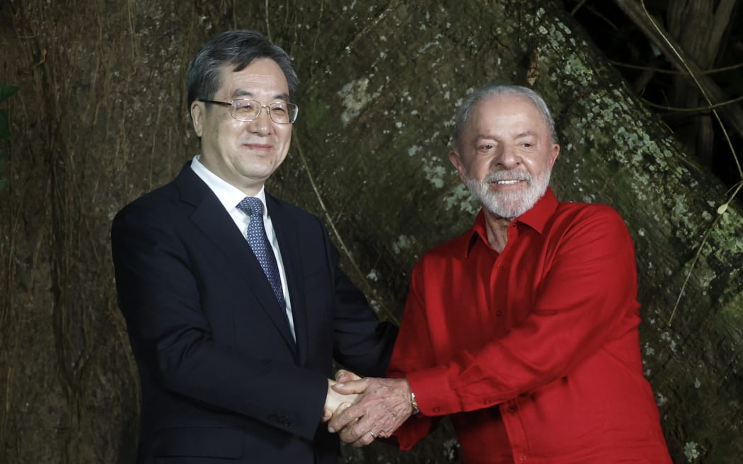 Brazil's President Luiz Inacio Lula da Silva (R) and China's Deputy Prime Minister Ding Xuexiang greet during a meeting in Belem, Para state, Brazil, on 5 November, 2025. Lula da Silva is preparing to host the COP30 UN climate summit next November 10 to 21, in Belem.
