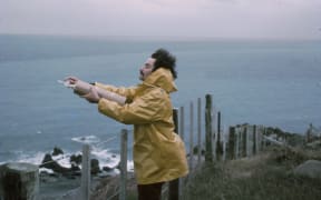 Dave Lowe taking an air flask sample at the edge of the Baring Head cliff in 1972.