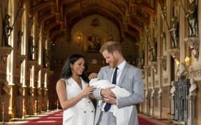 Britain's Prince Harry and Meghan, Duchess of Sussex, during a photocall with their newborn son, in St George's Hall at Windsor Castle, Windsor, south England, Wednesday May 8, 2019.