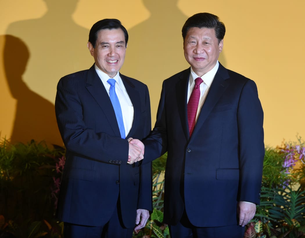 Chinese President Xi Jinping (right shakes hands with Taiwan President Ma Ying-jeou before their meeting