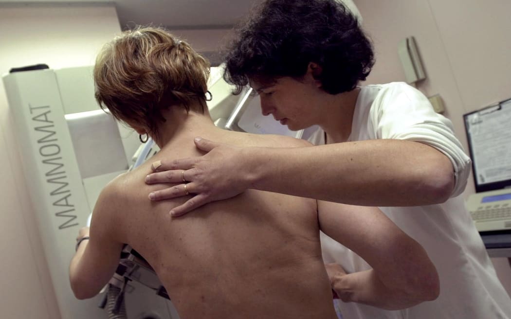 A woman having a mammogram.