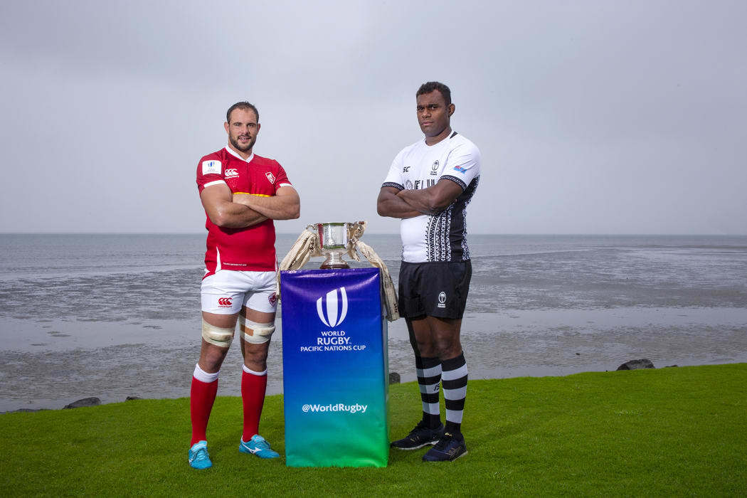 Canada's Tyler Ardron and Fiji's Leone Nakarawa pose with the World Rugby Pacific Nations Cup.