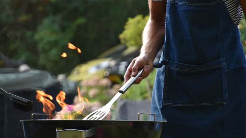 Person standing at a barbecue