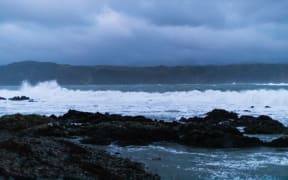 Waves break on Breaker Bay this evening as the size of the swell increases.
