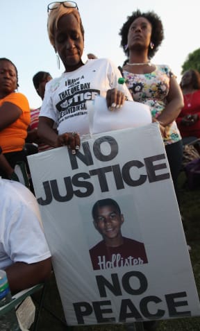 Protesters demonstrate at a rally for slain teenager Trayvon Martin on March 22, 2012 in Sanford, Florida.