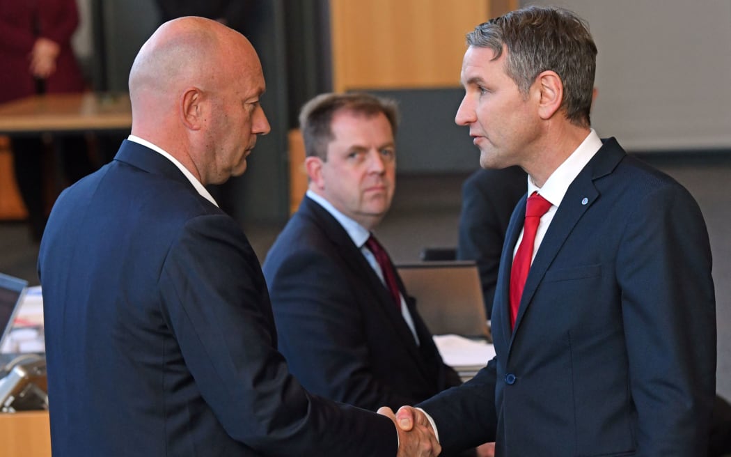 Björn Höcke, (R) parliamentary party leader of the AfD, congratulates Thomas Kemmerich (L), the new Prime Minister of Thuringia.