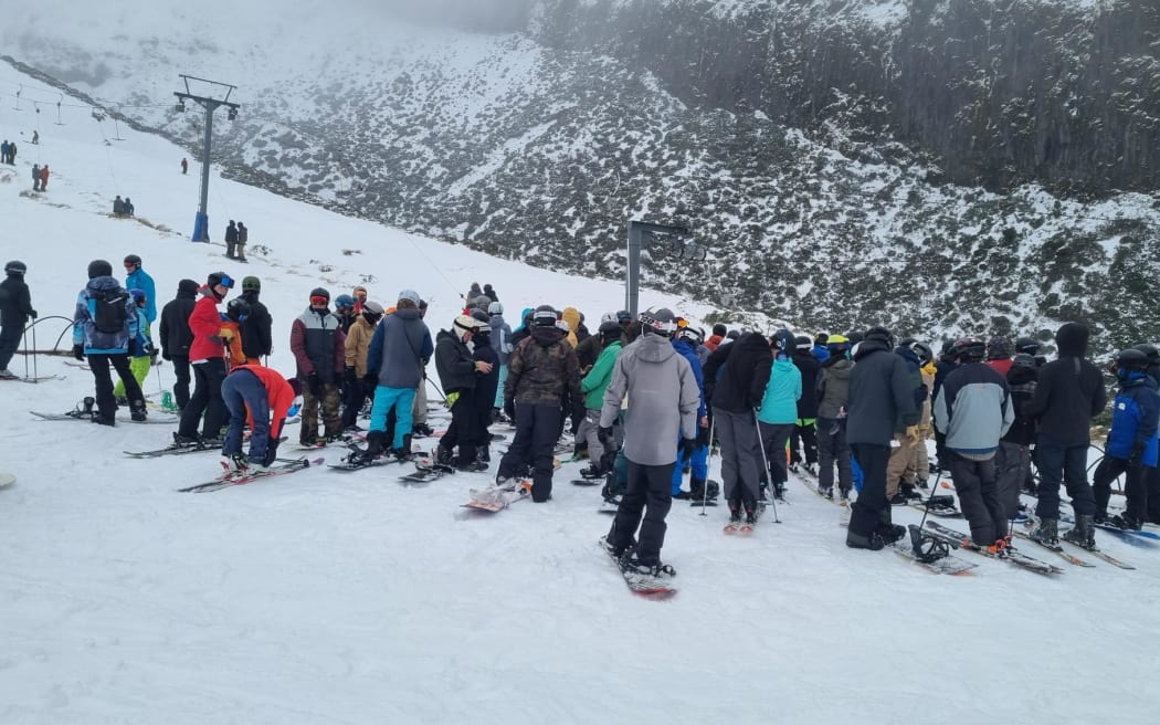 Snow sports fans line up for the T-bar tow. Between 200 and 300 people were expected at the Manganui Ski Area yesterday.