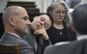 Kyle Rittenhouse sits with his attorneys after a lunch break and waits for proceedings to start at the Kenosha County Courthouse on November 9, 2021 in Kenosha, Wisconsin.