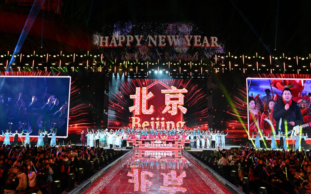 Dancers perform during the New Year’s countdown celebrations in Beijing on January 1, 2025. (Photo by ADEK BERRY / AFP)