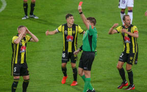 Referee Adam Kersey sends off Wellington Phoenix's Ryan Lowry.