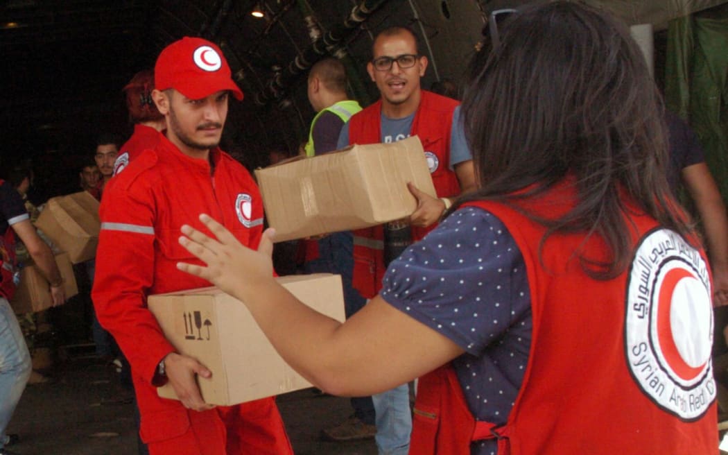 Two Russian planes carrying 80 tonnes of humanitarian aid landed in Syriad, amid reports Moscow is beefing up military support to its ally Damascus.