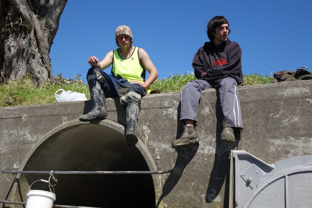 Whitebaiters Jagon Trent, left, and Keith Chapman take a smoko break on top of a stormwater pipe on the Waitara River, which they say is in good condition.