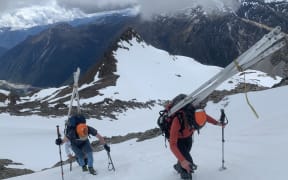 Researchers Heather Purdie & Andy Howell carrying monitoring equipment up to the Rolleston Glacier