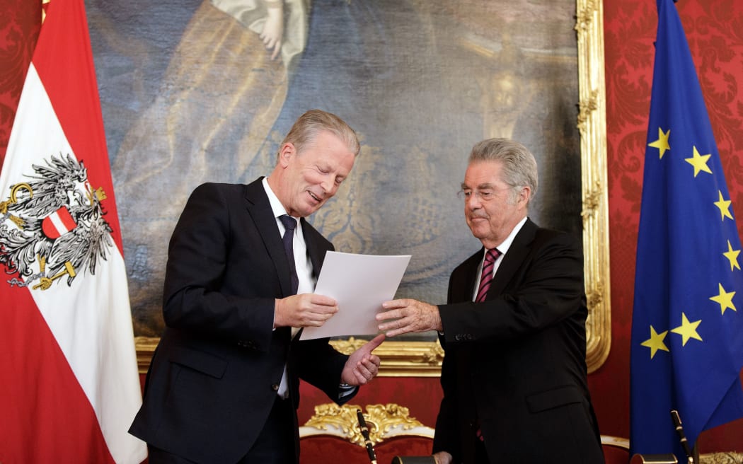 Austria's interim Chancellor Reinhold Mitterlehner is entrusted with government functions in Vienna by Austrian President Heinz Fischer.