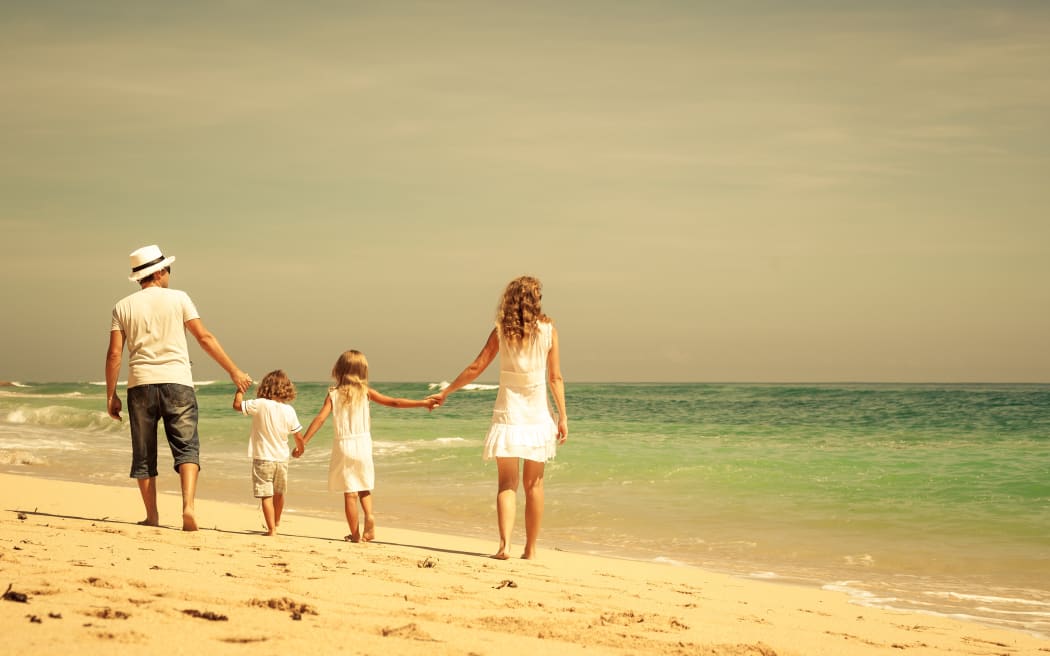 Family walking at the beach.