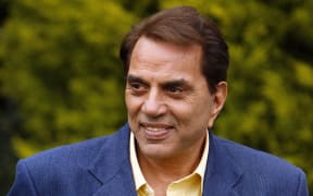 Indian film star Dharmendra Deol visits a family in Leeds on 6 June, 2007, as part of the promotion of the film Apne during the International Indian Film Academy Awards (IIFAs).