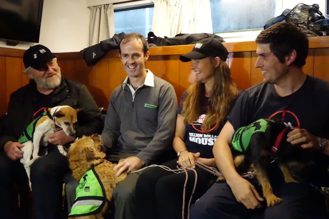 From left: Dog handler Brian Shields with Tui, DOC senior ranger Stephen Horn with Piri, DOC ranger Carol Nanning, monitoring trip leader Finlay Cox with Pipi.