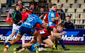 Jack Goodhue of the Crusaders scores a try in the tackle of Augustine Pulu of the Blues on 14 July, 2018.