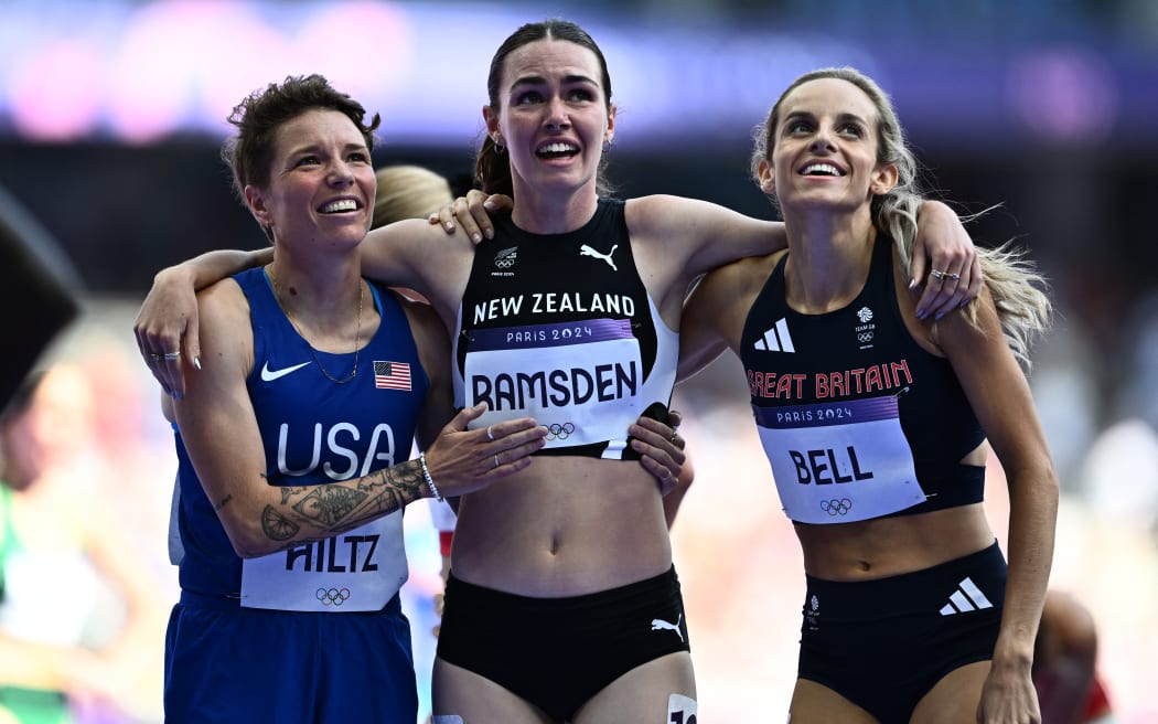 US' Nikki Hiltz, New Zealand's Maia Ramsden and Britain's Georgia Bell react after the women's 1500m heat of the athletics event at the Paris 2024 Olympic Games at Stade de France in Saint-Denis, north of Paris, on August 6, 2024. (Photo by Jewel SAMAD / AFP)