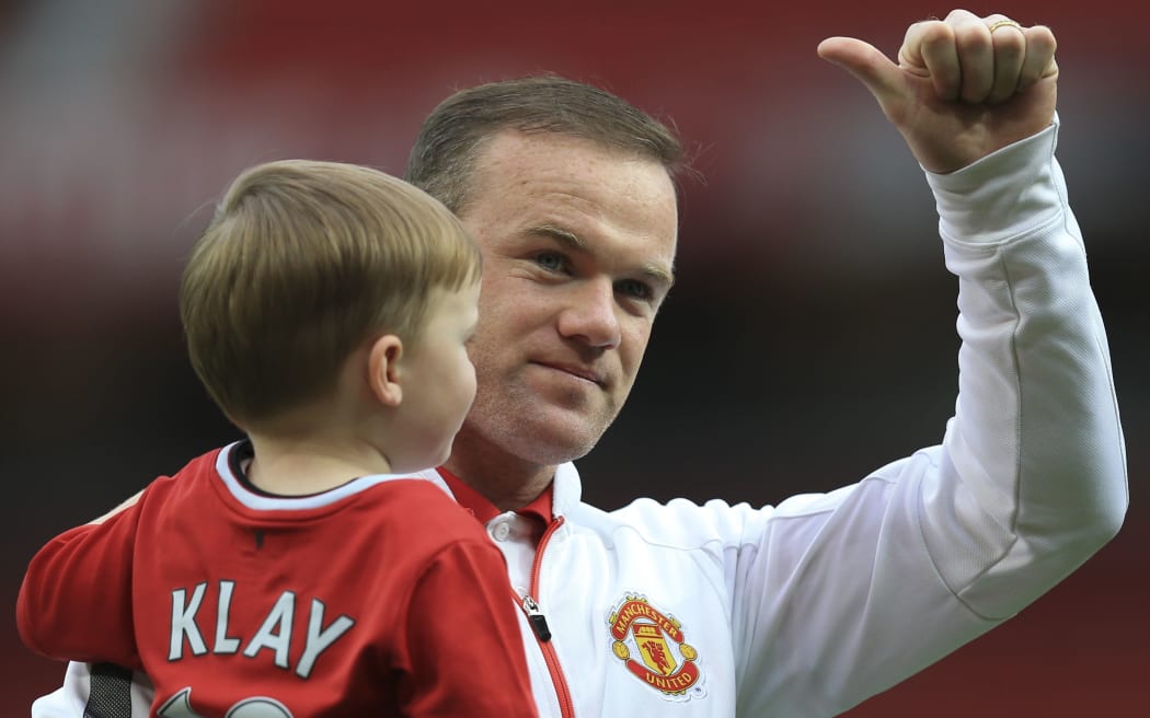 17 May 2015 - English Premier League - Manchester United v Arsenal - Wayne Rooney of Manchester United and his Son, Klay on the lap of appreciation.
