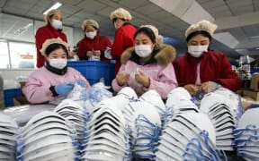 Workers producing face masks at a factory in Handan in China's northern Hebei province, on 22 January 2020.