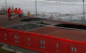 Workers inspecting the sink-holes in June.