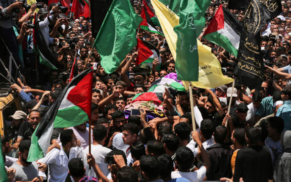 Palestinian mourners carry the body of 21 years old Razan al-Najjar during her funeral after she was shot dead by Israeli soldiers, in Khan Yunis on June 2, 2018.